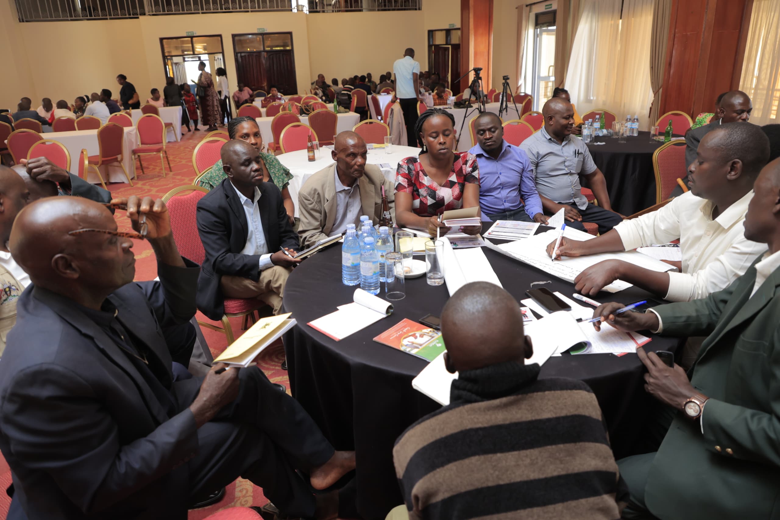 A group of people around a table doing some work